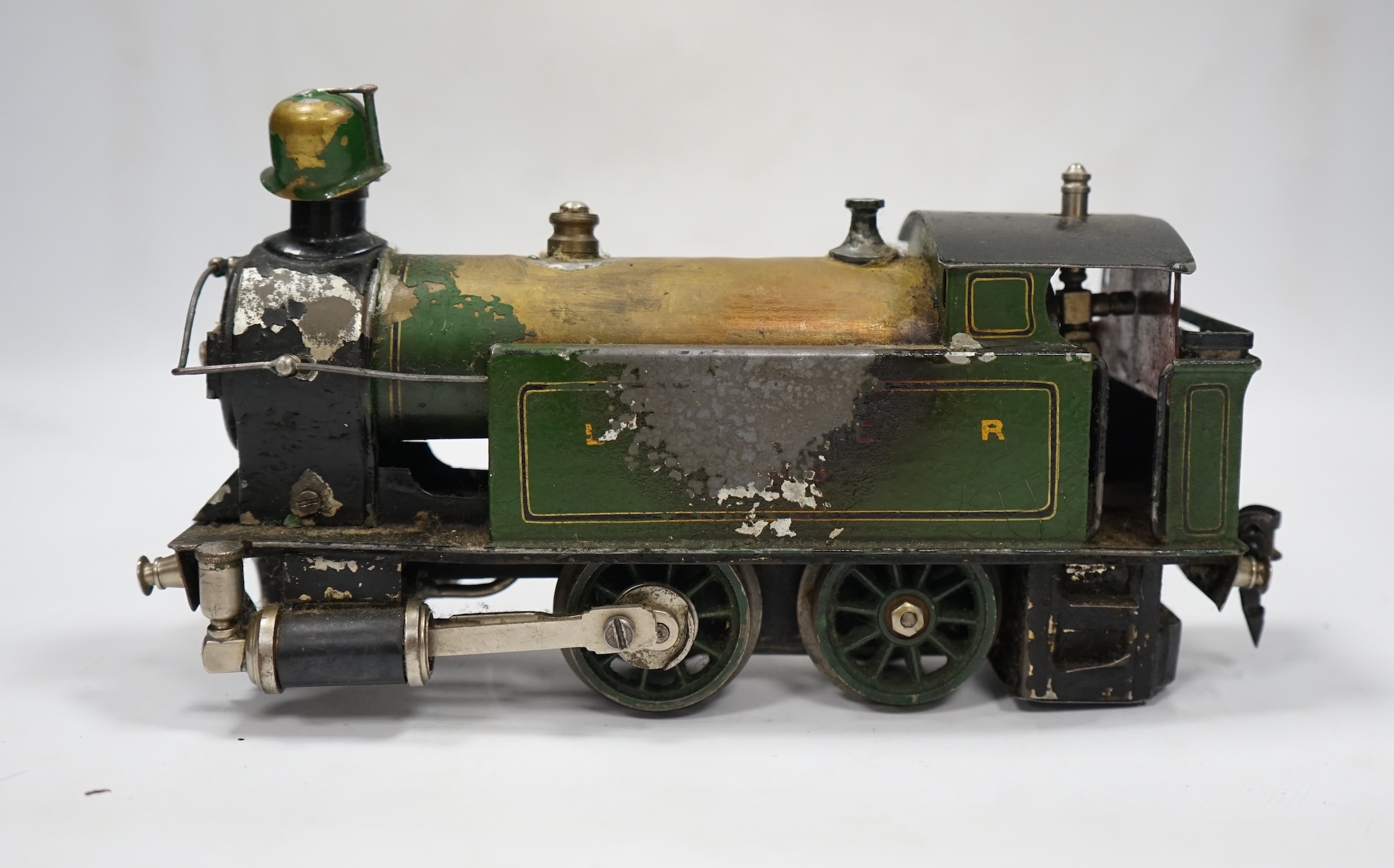 A Trix Twin Railway 00 gauge train set box containing; four locomotives, eight bogie coaches, two railcars, and six freight wagons, together with a live steam Marklin 0-4-0T LNER locomotive. Condition - poor to fair.